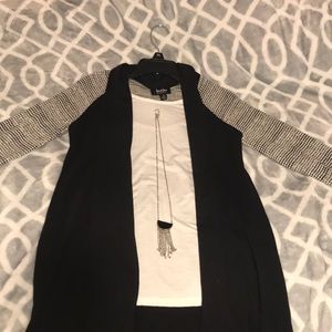 A long sleeve shirt with necklace.